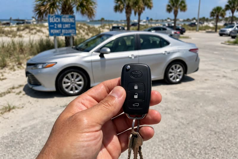Toyota Camry key handover at a beach parking lot